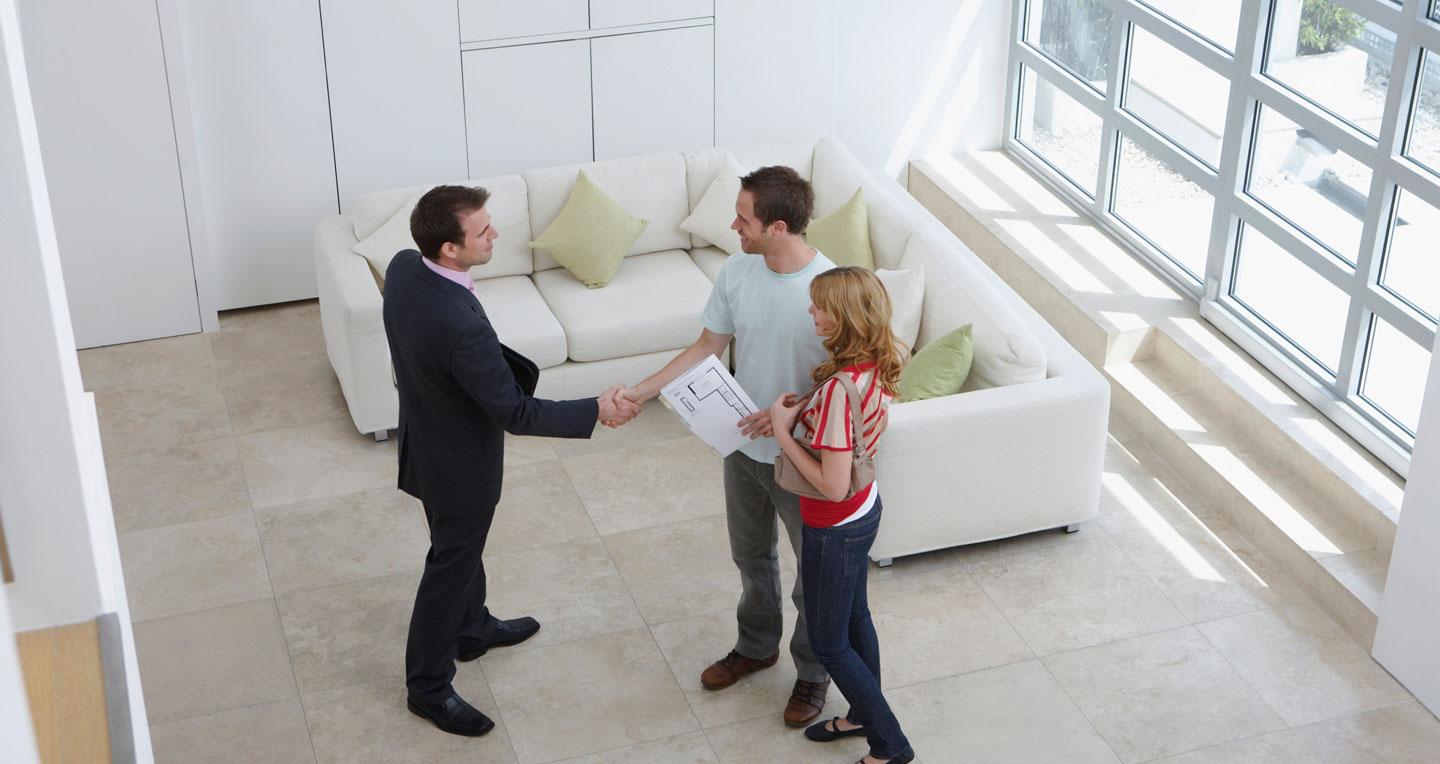 couple shaking hands with agent
